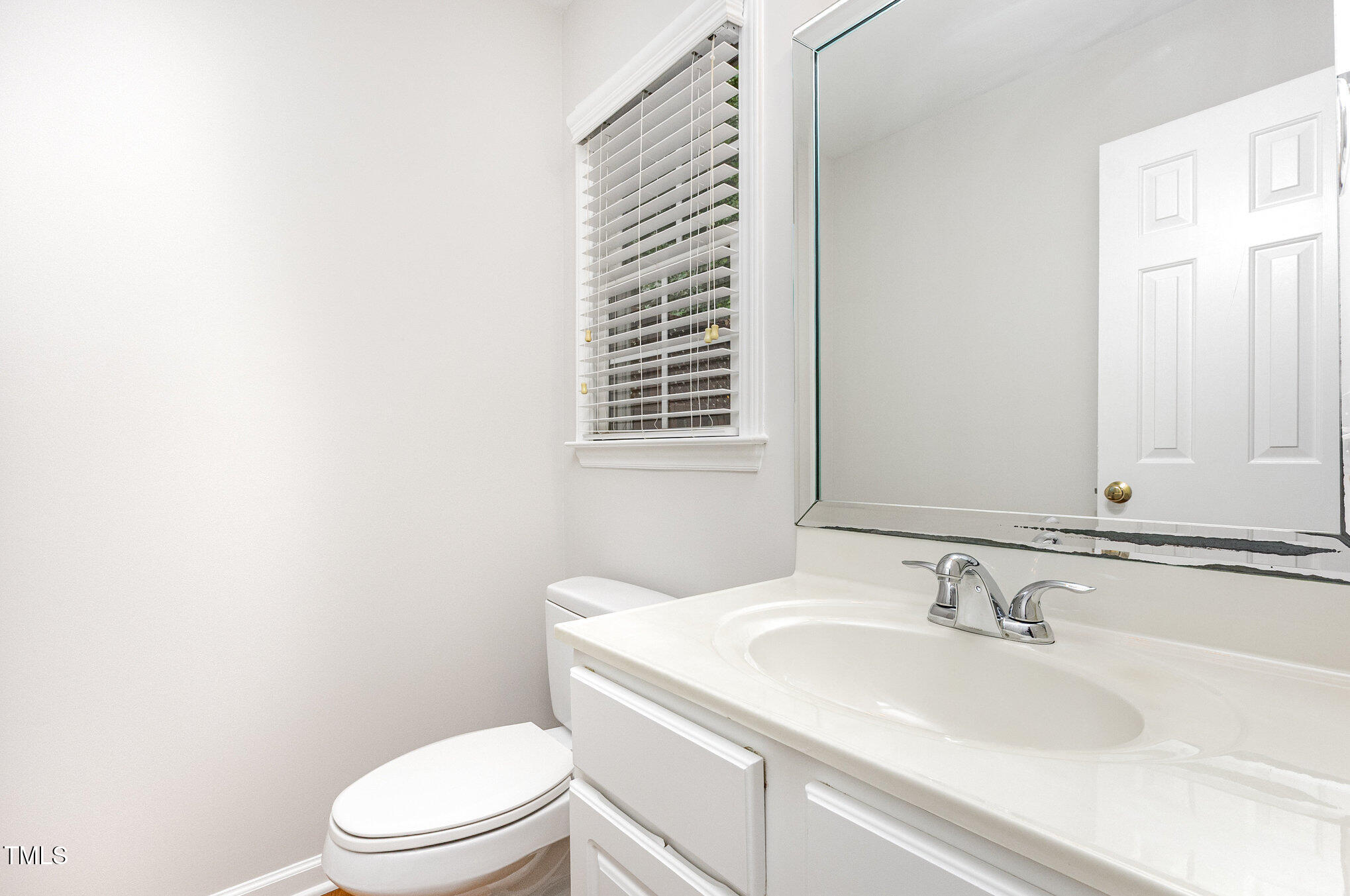 8401 Hobhouse Circle Raleigh, NC 27615 - Photo 12 of 27 a bathroom with a sink toilet and mirror