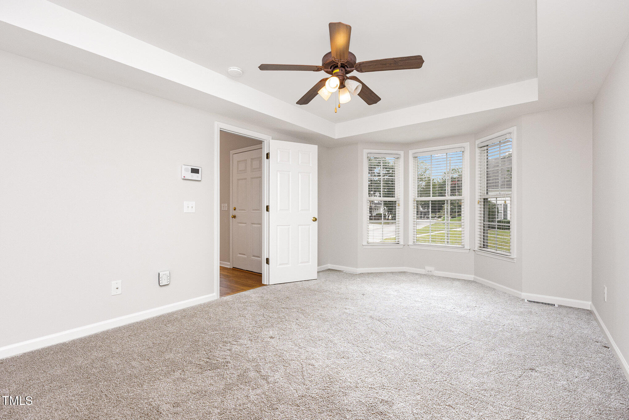 8401 Hobhouse Circle Raleigh, NC 27615 - Photo 13 of 27 a view of a livingroom with a ceiling fan & windows