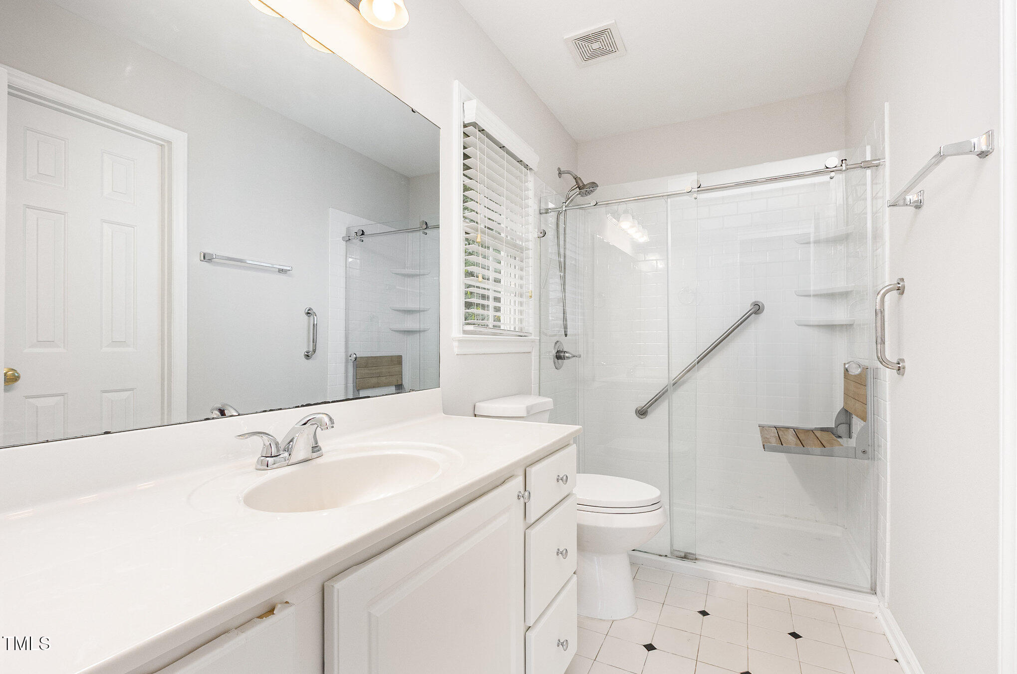 8401 Hobhouse Circle Raleigh, NC 27615 - Photo 14 of 27 a bathroom with a sink a toilet and a mirror