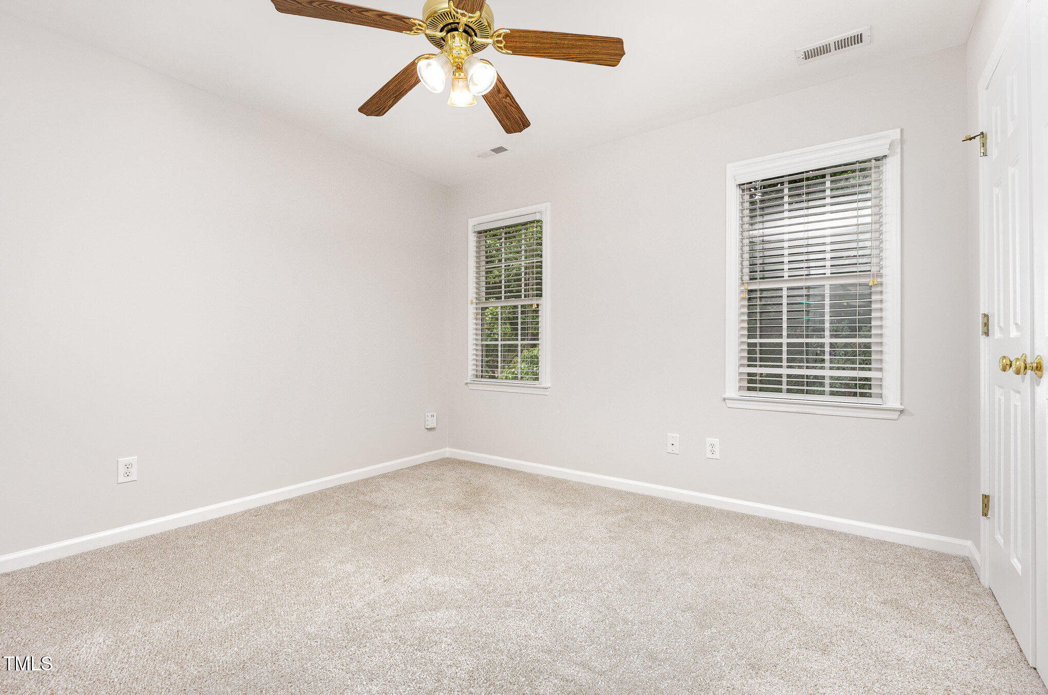 8401 Hobhouse Circle Raleigh, NC 27615 - Photo 16 of 27 an empty room with windows and fan