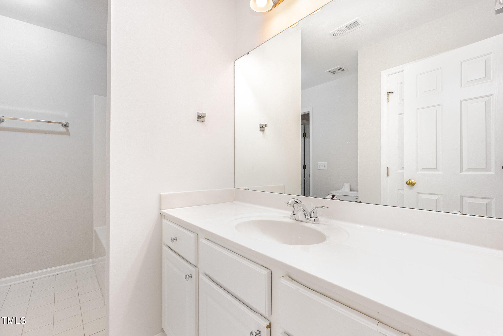 8401 Hobhouse Circle Raleigh, NC 27615 - Photo 19 of 27 a bathroom with a sink and a mirror