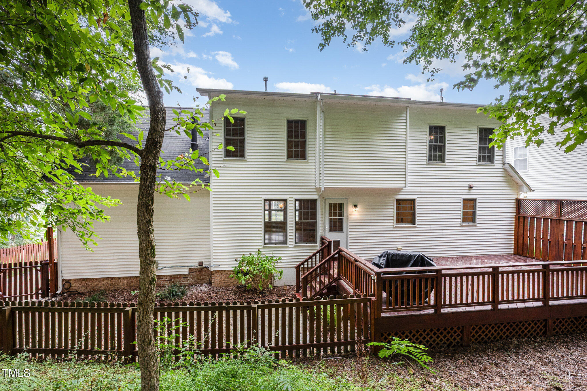 8401 Hobhouse Circle Raleigh, NC 27615 - Photo 23 of 27 a view of a house with a small yard and wooden fence