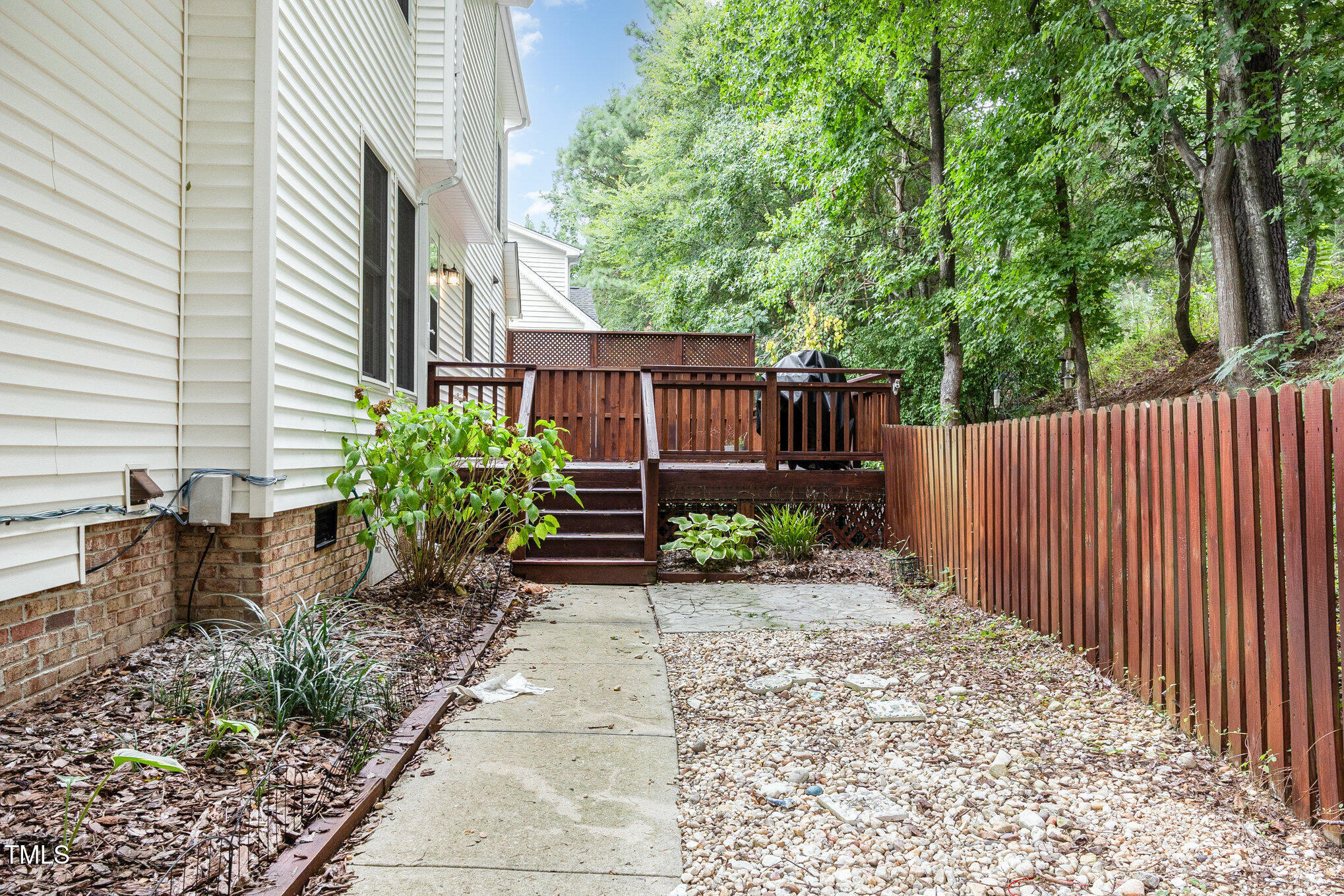 8401 Hobhouse Circle Raleigh, NC 27615 - Photo 24 of 27 a view of a backyard with potted plants and large trees