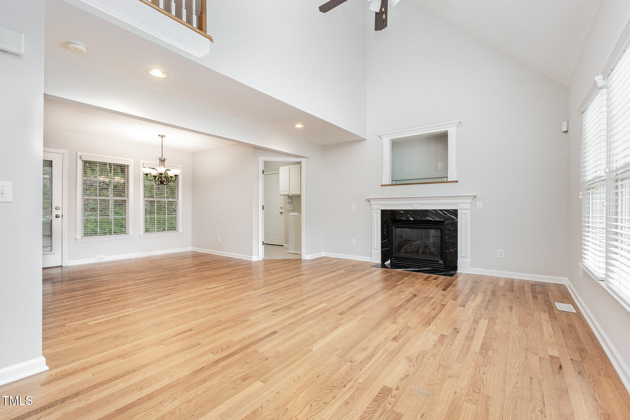 8401 Hobhouse Circle Raleigh, NC 27615 - Photo 5 of 27 a view of empty room with wooden floor and fireplace