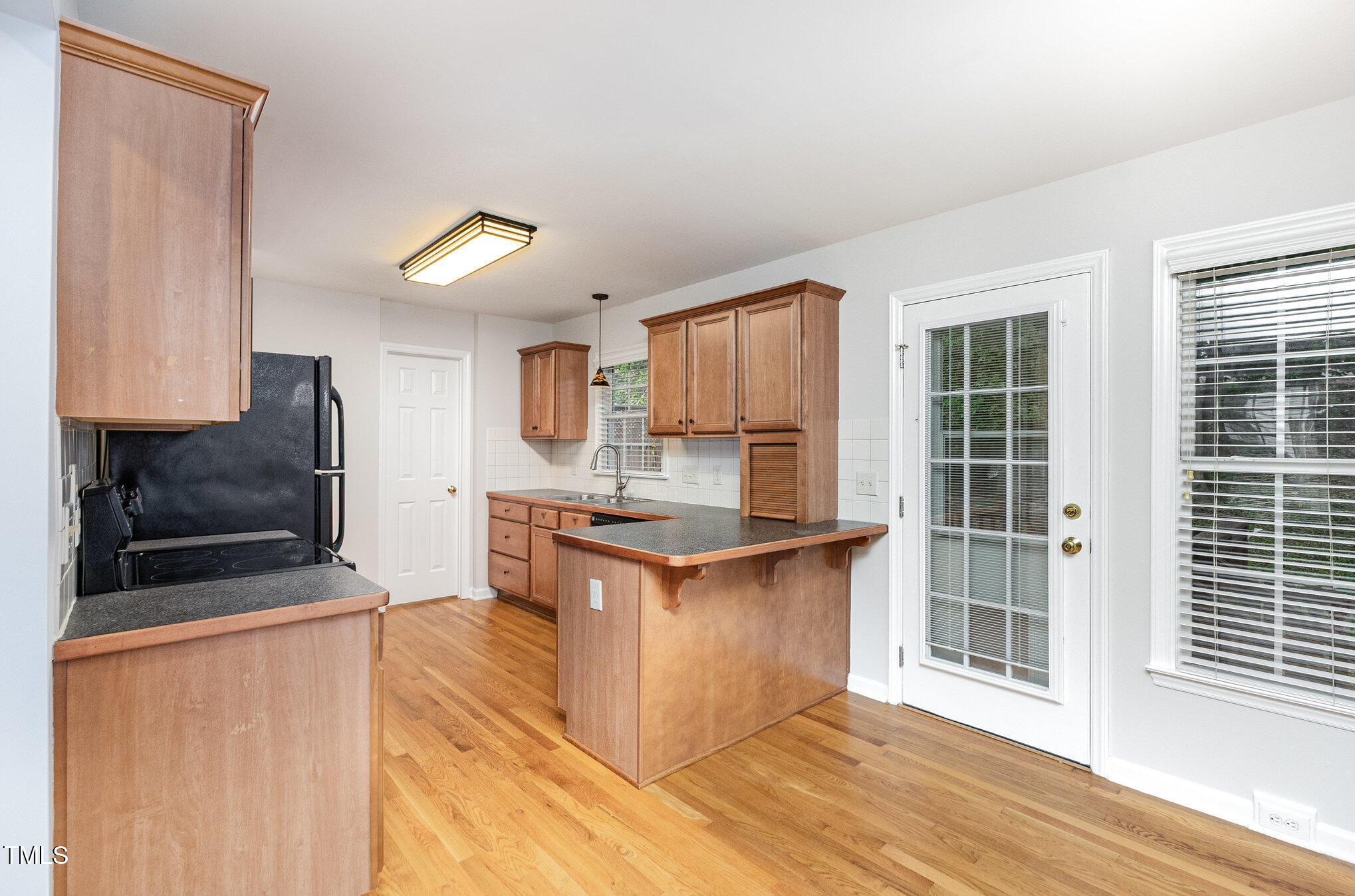 8401 Hobhouse Circle Raleigh, NC 27615 - Photo 9 of 27 a kitchen with granite countertop a stove top oven and cabinets