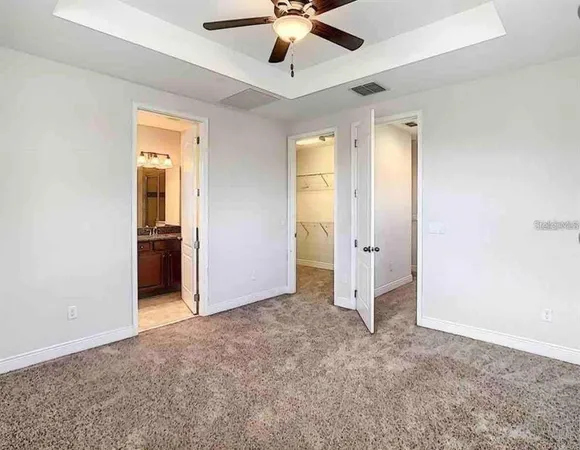 an empty room with fan and entrance