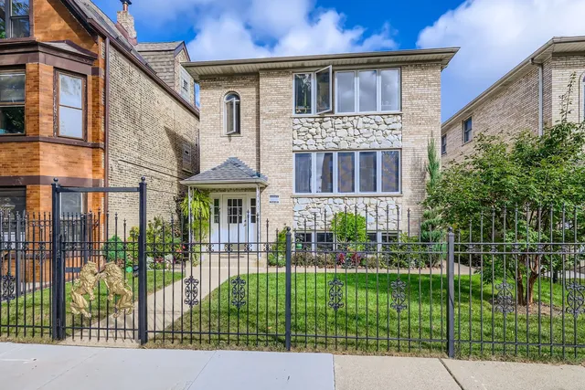 a front view of a house with a garden