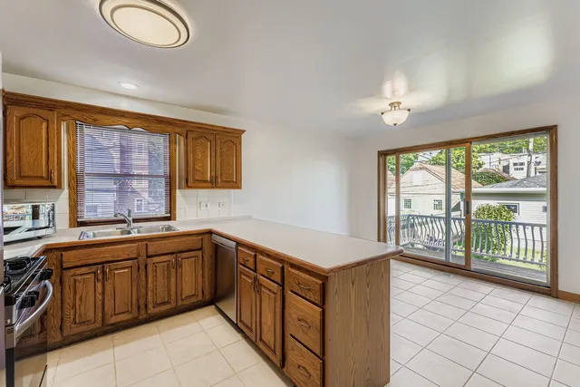 a kitchen with a sink window and cabinets