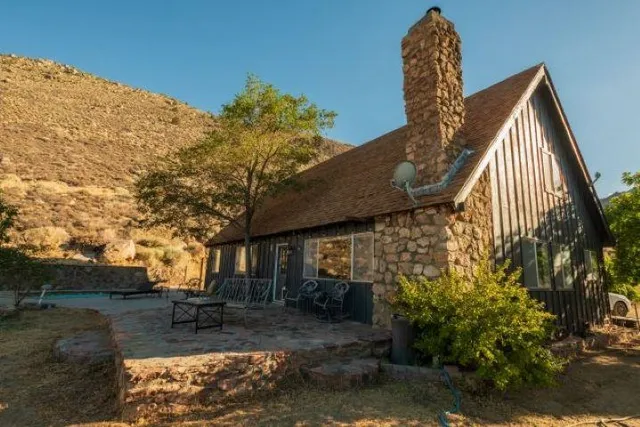 a view of a house with backyard and sitting area