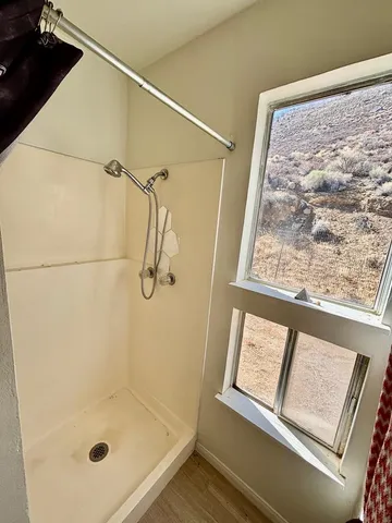 a bathroom with a glass shower door