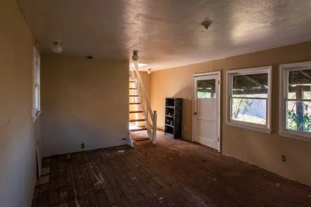 an empty room with windows and closet