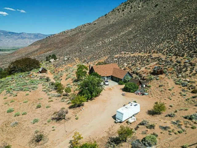 a view of a houses with mountains in the background