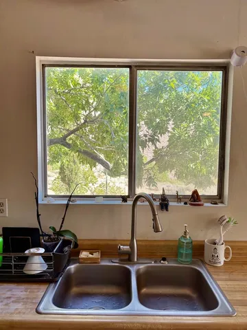 a kitchen with a sink a large window
