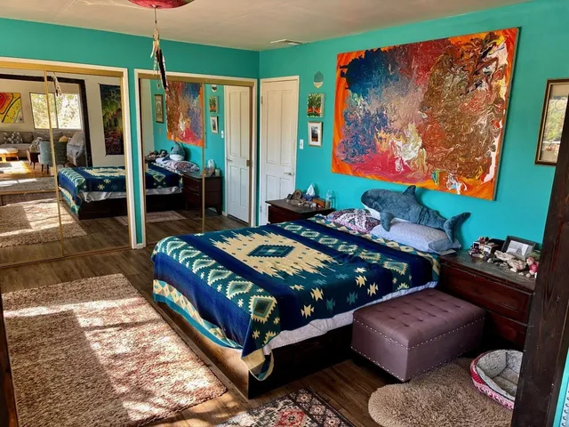 a bed sitting in a bedroom next to a window