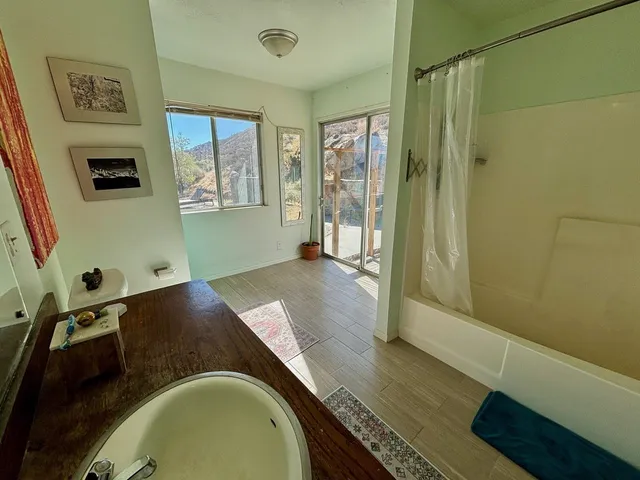 a bathroom with a sink a mirror and a shower