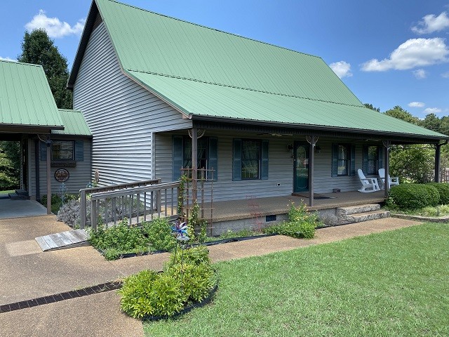 398 Azbill Road Lexington, TN 38351 - Photo 1 of 40 a front view of a house with garden