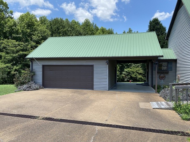 398 Azbill Road Lexington, TN 38351 - Photo 2 of 40 a front view of a house with a garden and yard