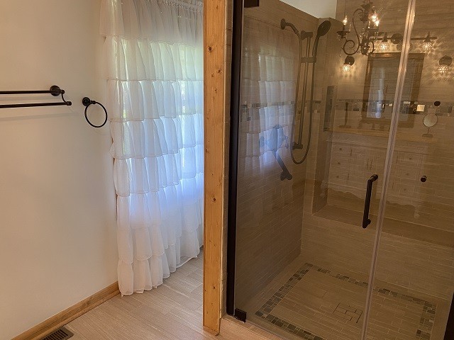 398 Azbill Road Lexington, TN 38351 - Photo 21 of 40 a bathroom with a glass shower door