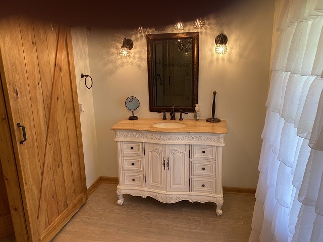 398 Azbill Road Lexington, TN 38351 - Photo 22 of 40 a bathroom with a sink vanity and a mirror