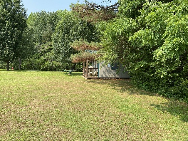 398 Azbill Road Lexington, TN 38351 - Photo 33 of 40 a view of a swimming pool with an outdoor space and seating area