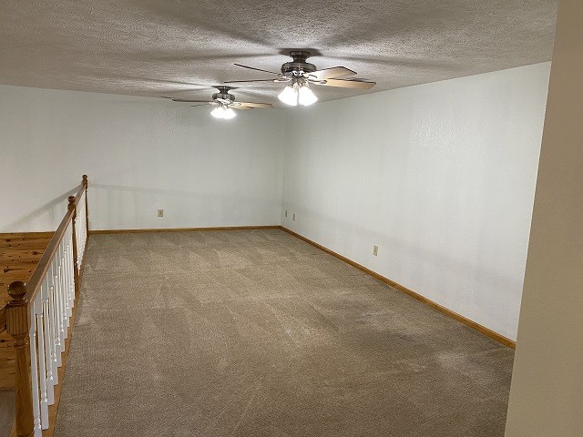398 Azbill Road Lexington, TN 38351 - Photo 8 of 40 an empty room with a chandelier fan and wooden floor