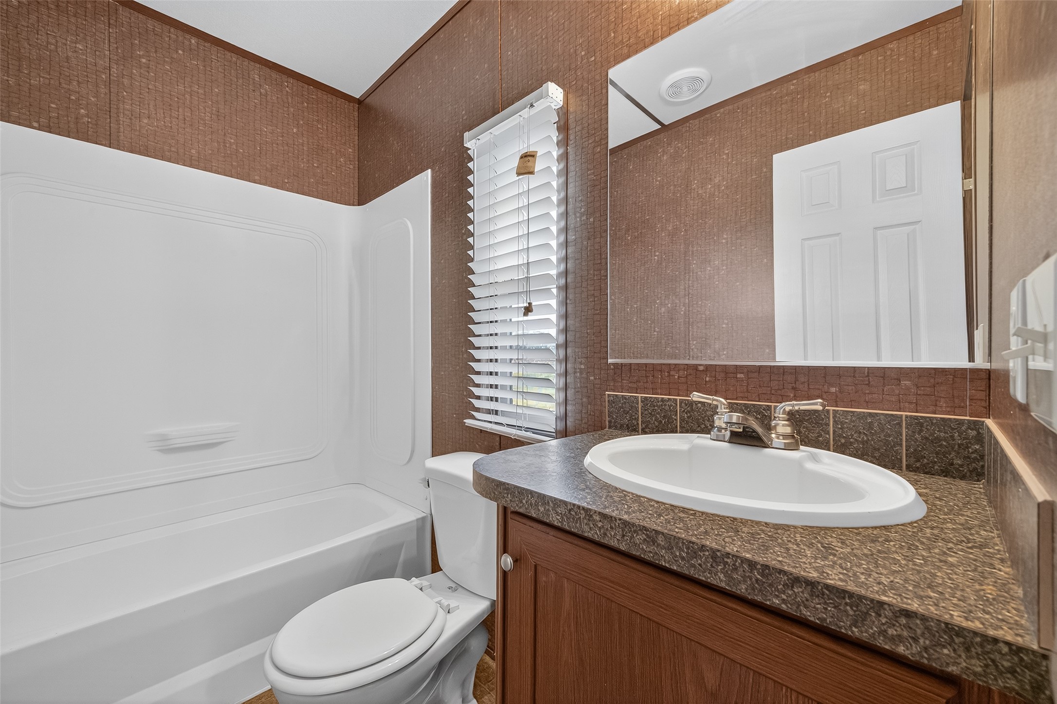 13411 Zamanek Road Needville, TX 77461 - Photo 30 of 40 a bathroom with a granite countertop sink toilet and shower