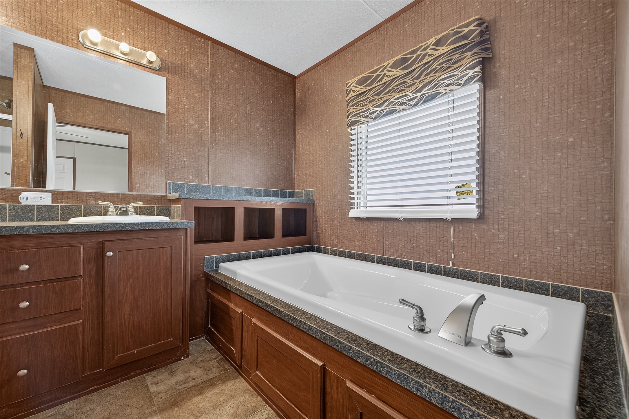 13411 Zamanek Road Needville, TX 77461 - Photo 34 of 40 a spacious bathroom with a tub sink and mirror