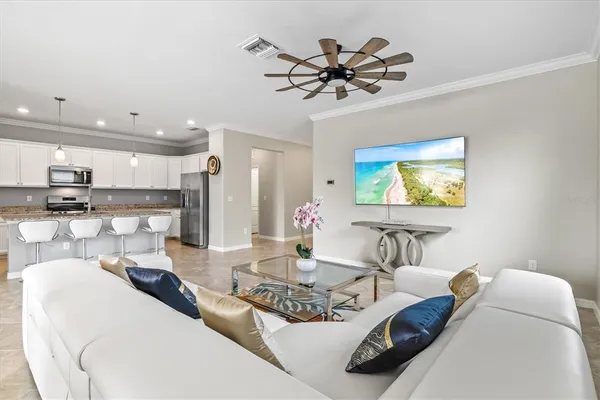 a view of a dining room with furniture and chandelier