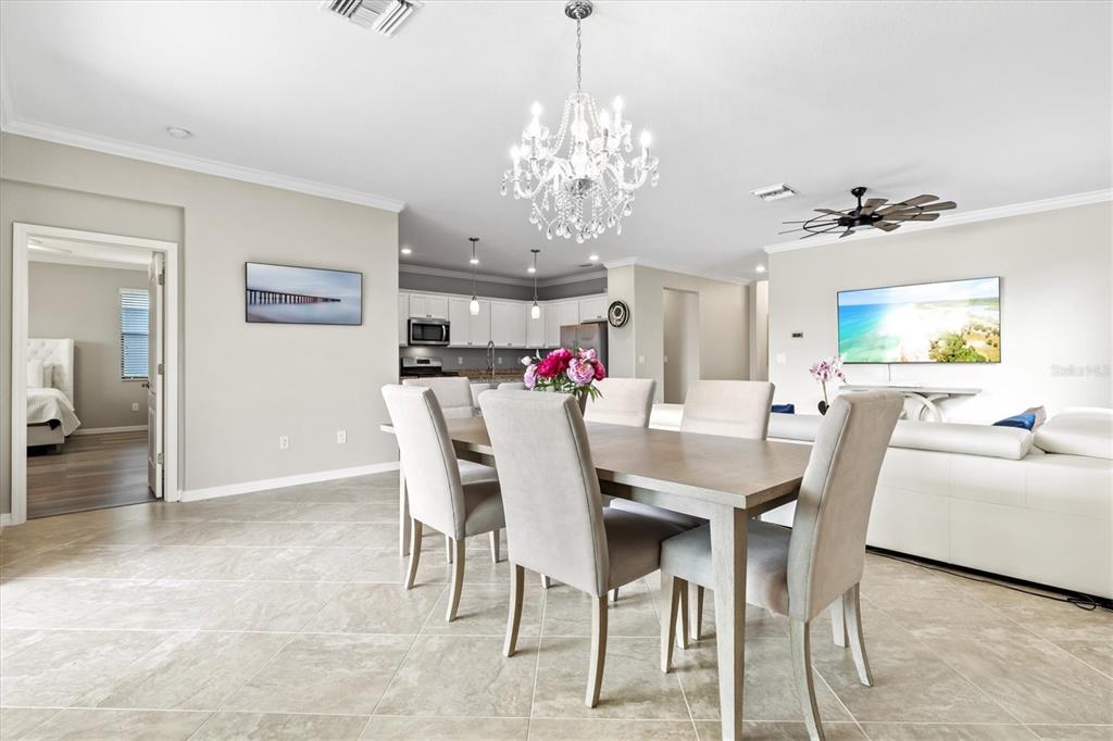 17030 Blue Ridge Place Bradenton, FL 34211 - Photo 12 of 65 a view of a dining room with furniture and chandelier
