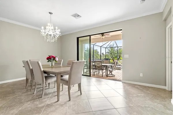 a dining room with furniture a chandelier and a rug