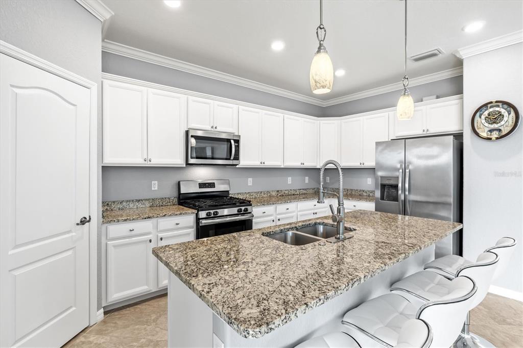 17030 Blue Ridge Place Bradenton, FL 34211 - Photo 15 of 65 a kitchen with stainless steel appliances granite countertop a sink stove and refrigerator