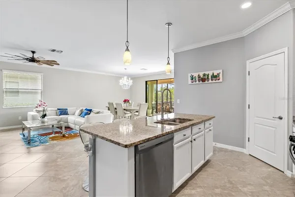 a bedroom with a large bed a chandelier and a window