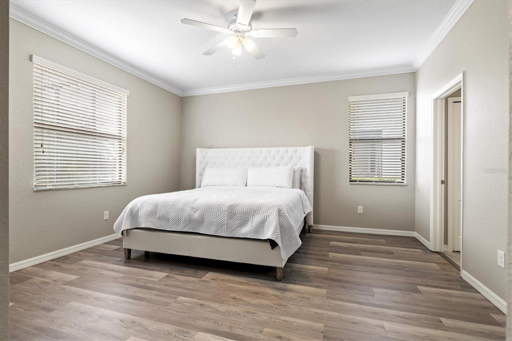 17030 Blue Ridge Place Bradenton, FL 34211 - Photo 19 of 65 a bedroom with a bed and wooden floor