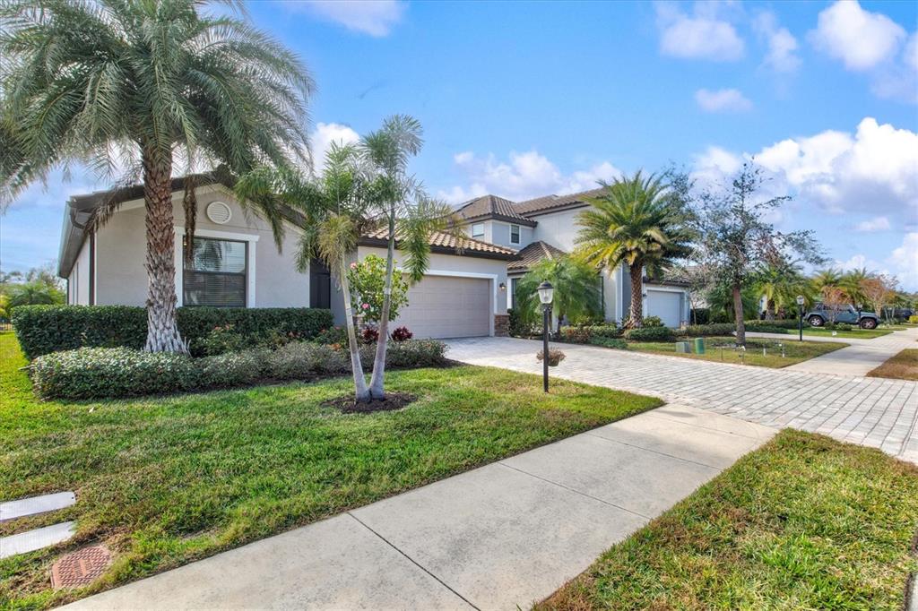 17030 Blue Ridge Place Bradenton, FL 34211 - Photo 3 of 65 a front view of a house with a yard and palm tree