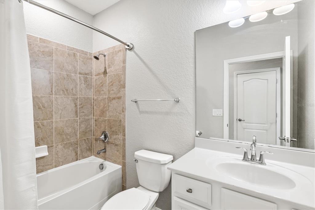 17030 Blue Ridge Place Bradenton, FL 34211 - Photo 34 of 65 a bathroom with a bathtub shower sink vanity and toilet
