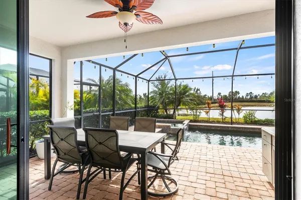 a view of a patio with a table and chairs under an umbrella