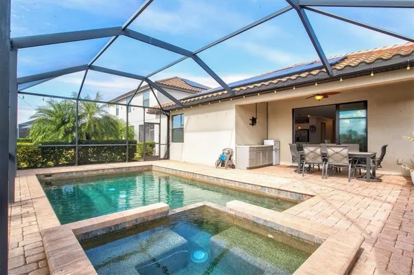 a view of an ocean & house with swimming pool and outdoor space