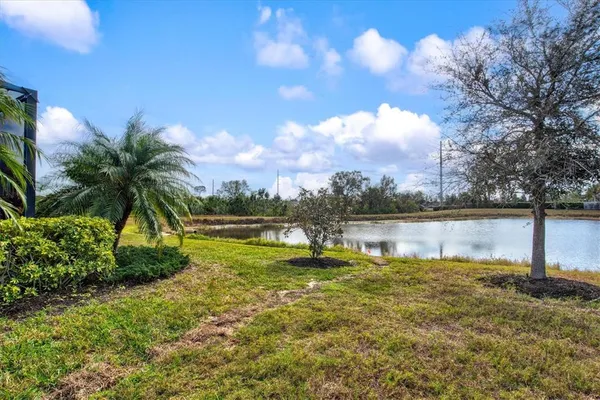 a front view of a house with a yard and lake view