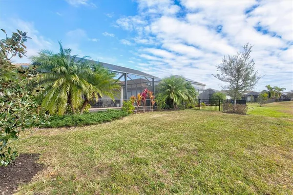 an aerial view of swimming pool with outdoor space and lake view in back