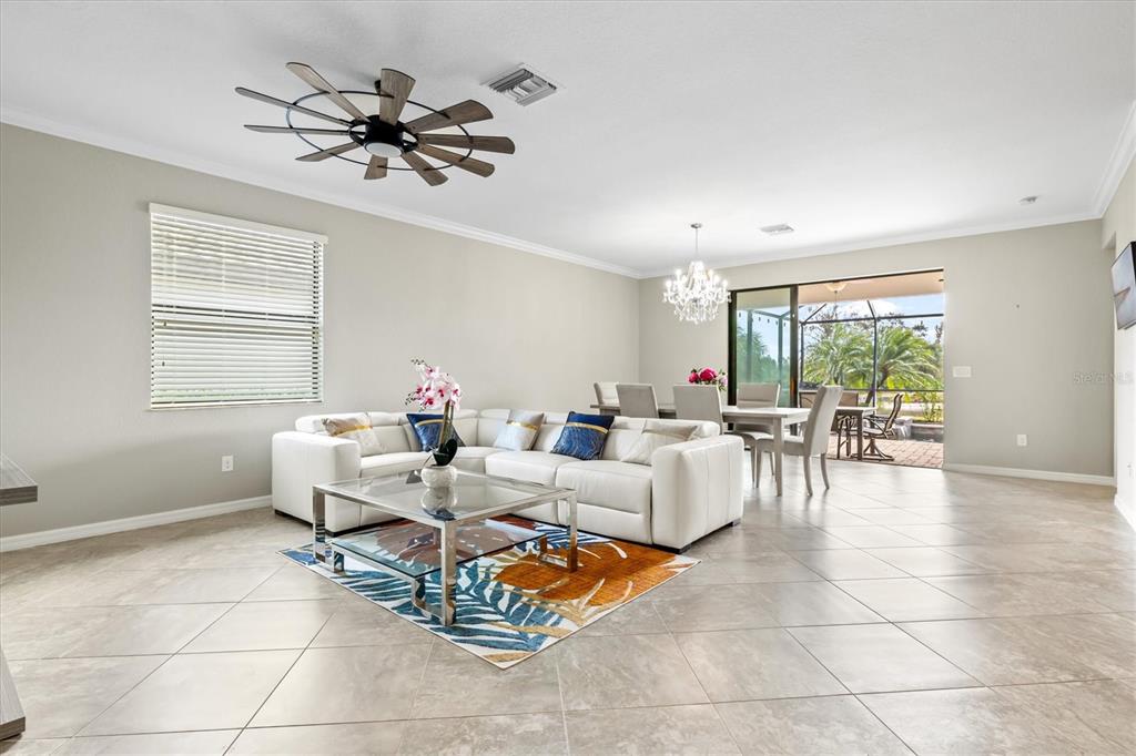 17030 Blue Ridge Place Bradenton, FL 34211 - Photo 7 of 65 a living room with furniture a chandelier and a window