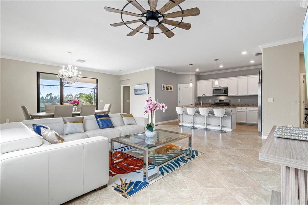 17030 Blue Ridge Place Bradenton, FL 34211 - Photo 8 of 65 a living room with furniture and a chandelier