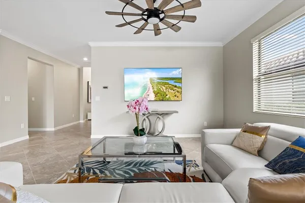 a living room with furniture and a chandelier