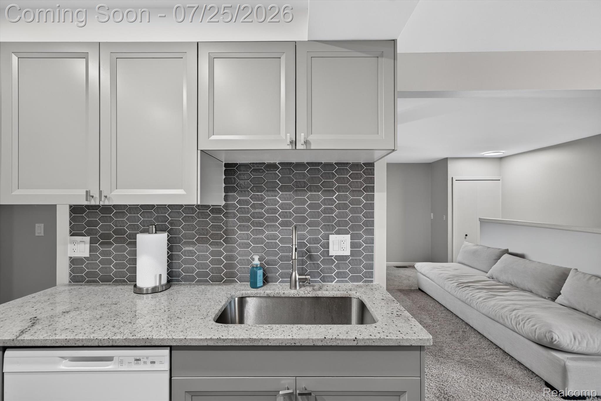 51116 South Foster Road New Baltimore, MI 48047 - Photo 13 of 31 Kitchenette featuring light gray cabinetry, a speckled countertop, undermount stainless steel sink, and a geometric tile backsplash