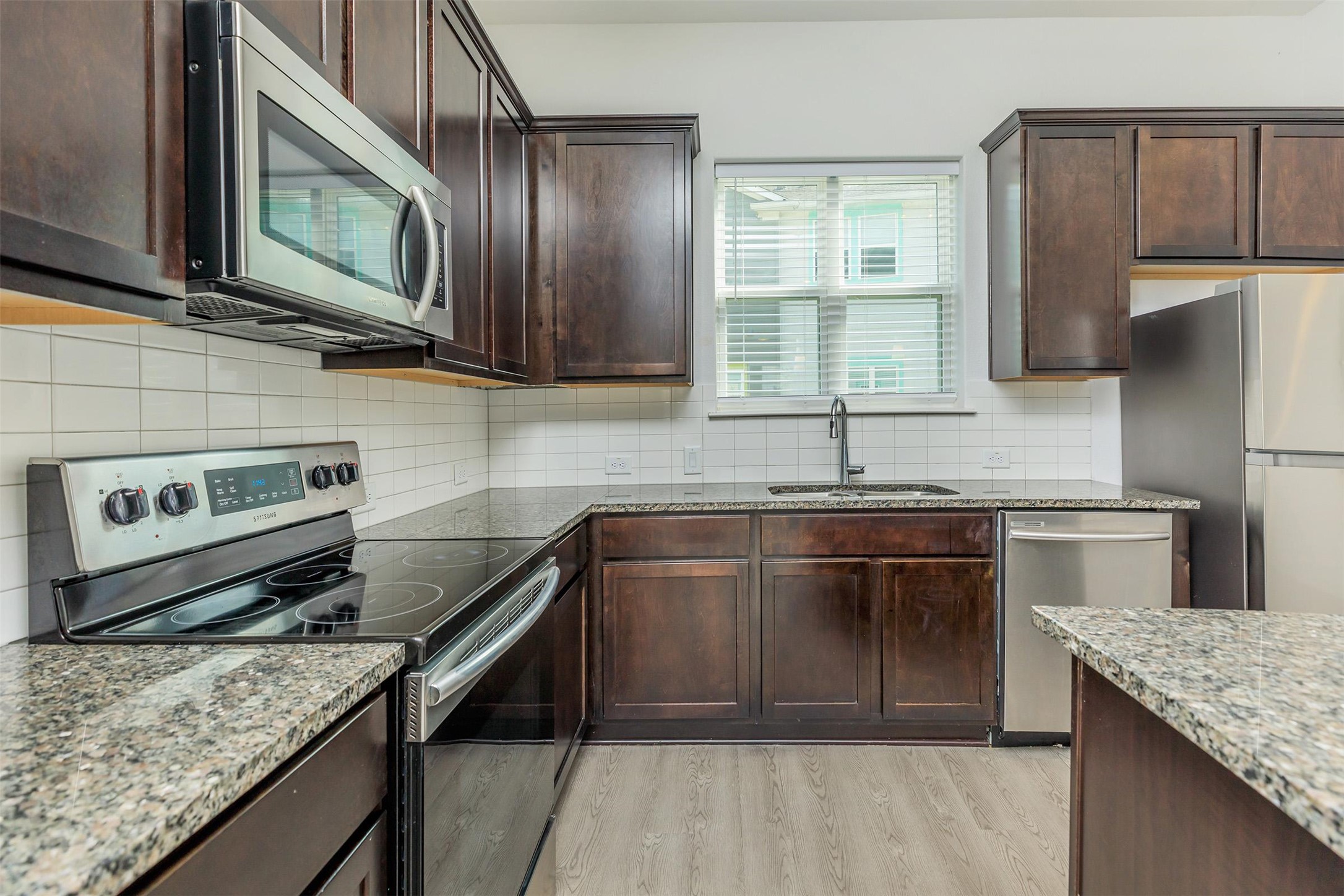 a kitchen with a stove and a microwave
