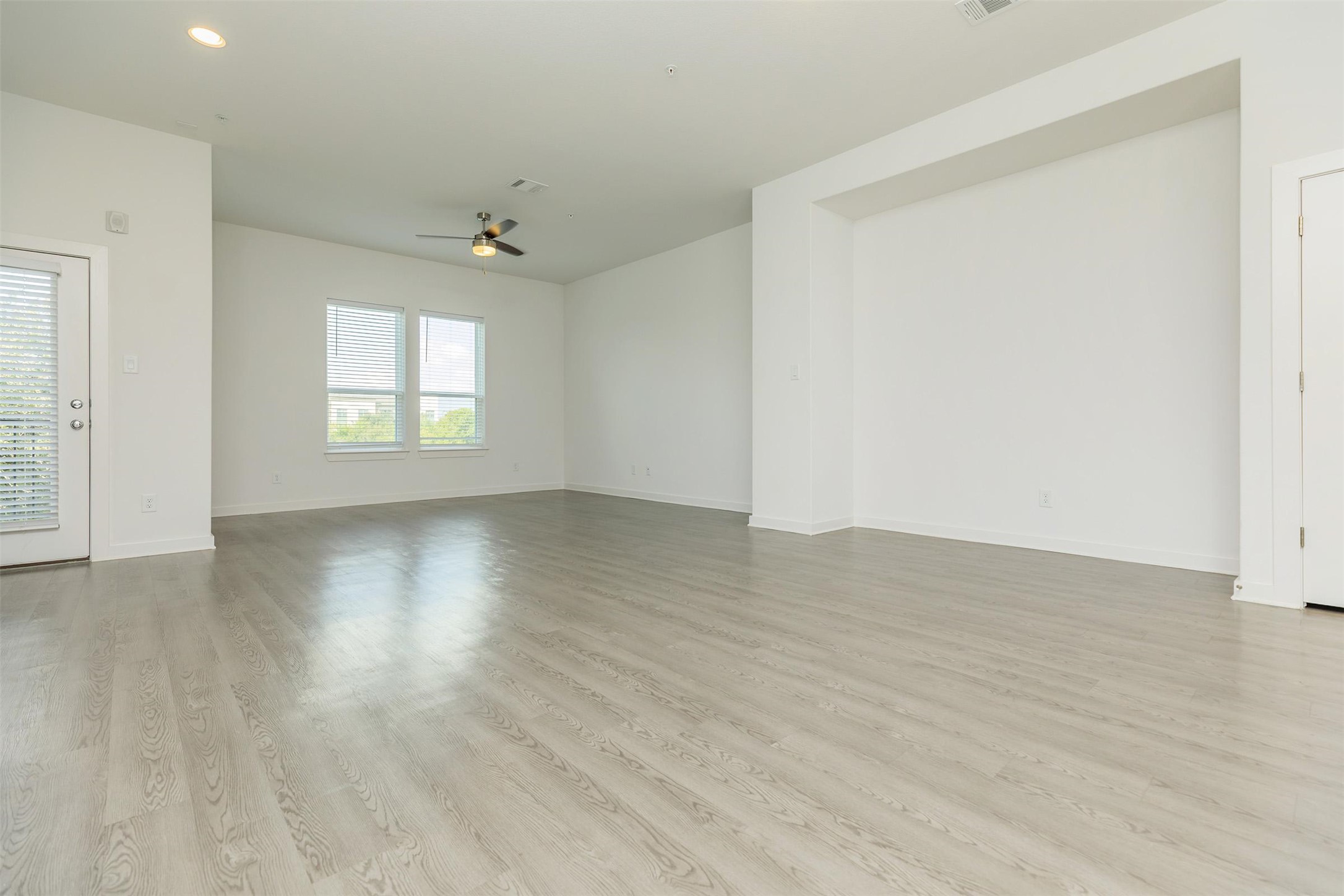 428 Ozark Trail Leander, TX 78641 - Photo 4 of 27 an empty room with wooden floor and windows