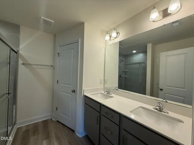 a bathroom with a double vanity sink and mirror