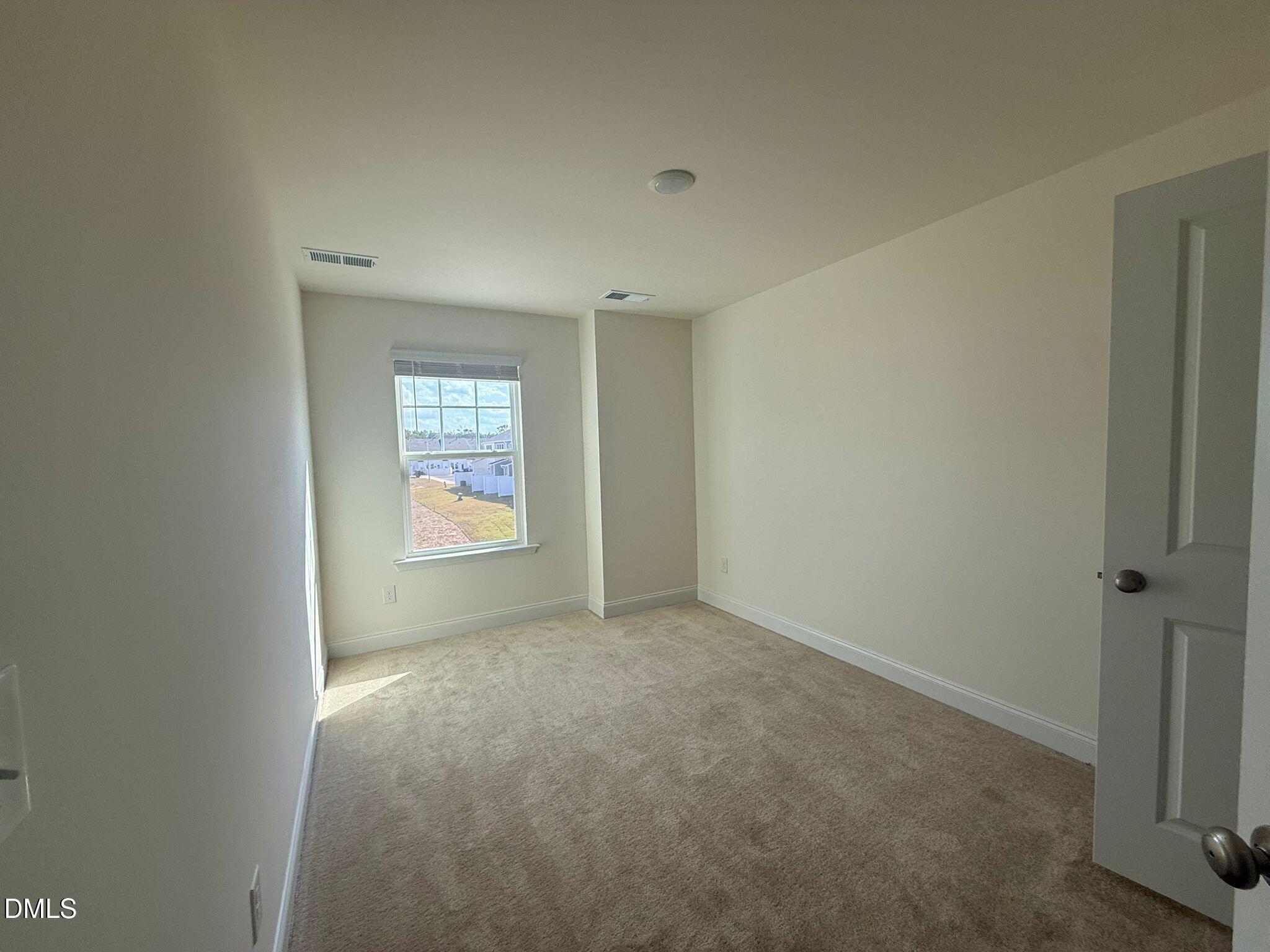 66 Bloodroot Street Angier, NC 27501 - Photo 14 of 16 an empty room with windows