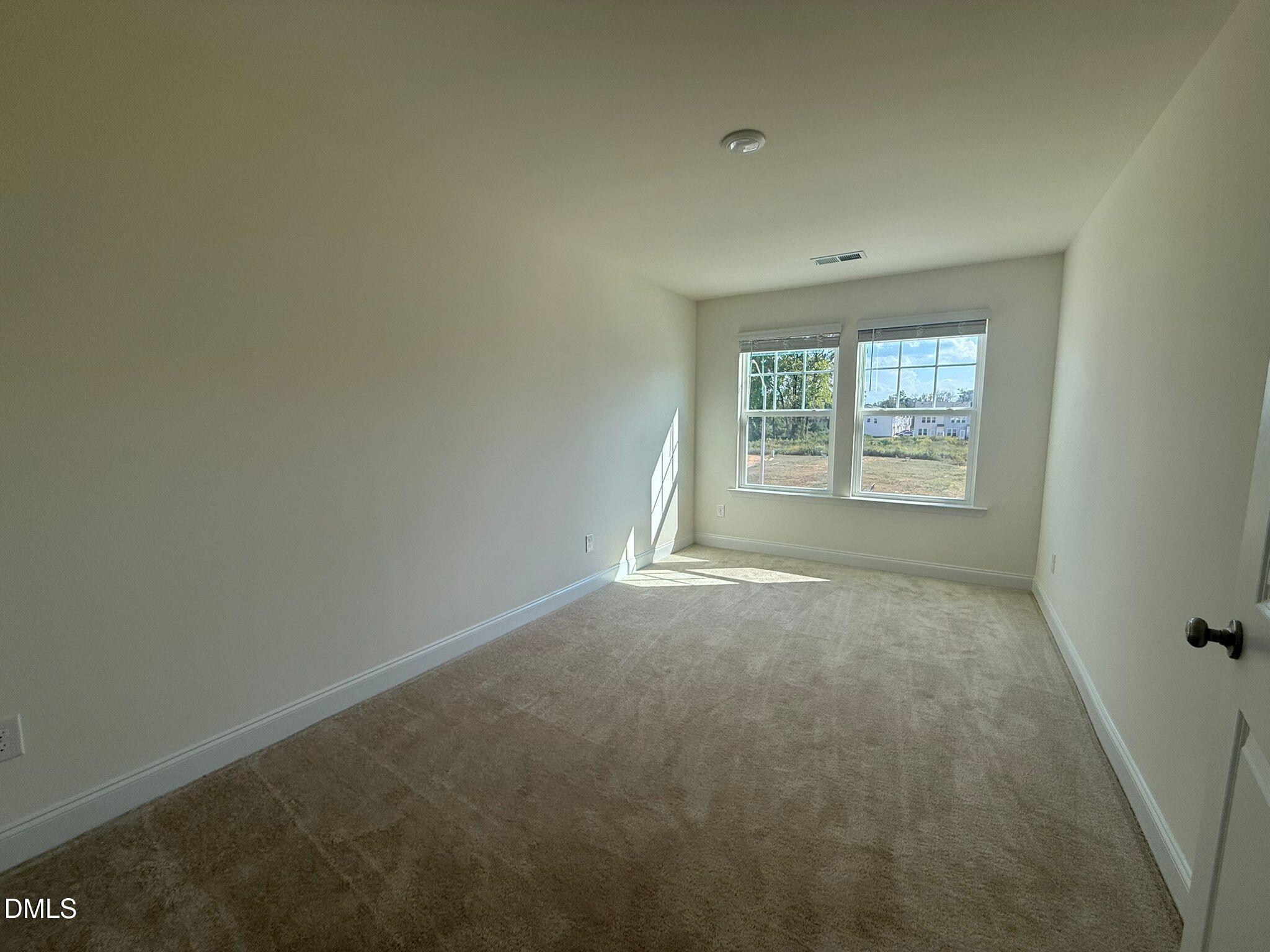 66 Bloodroot Street Angier, NC 27501 - Photo 16 of 16 an empty room with a window