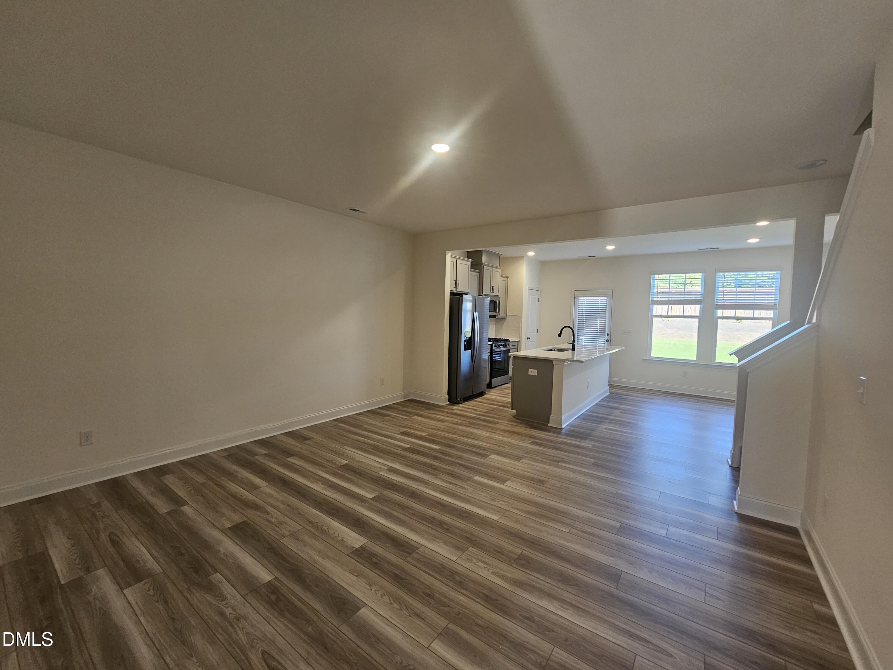 66 Bloodroot Street Angier, NC 27501 - Photo 2 of 16 an empty room with wooden floor and windows