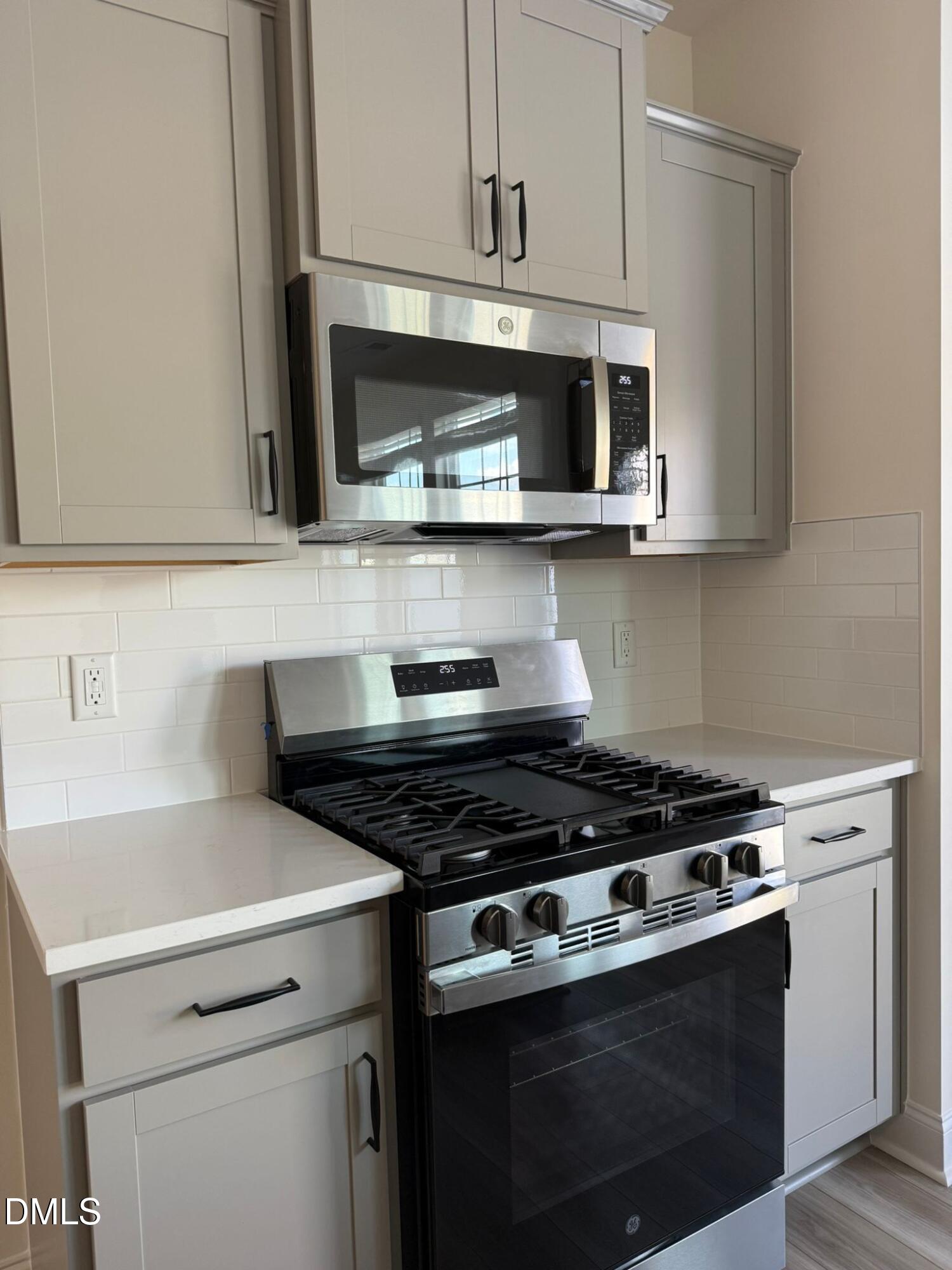 66 Bloodroot Street Angier, NC 27501 - Photo 4 of 16 a kitchen with stainless steel appliances granite countertop a stove and a microwave